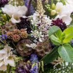 A close up of flowers and leaves in the bouquet