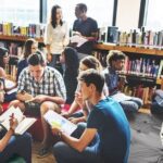 A group of people sitting in the library