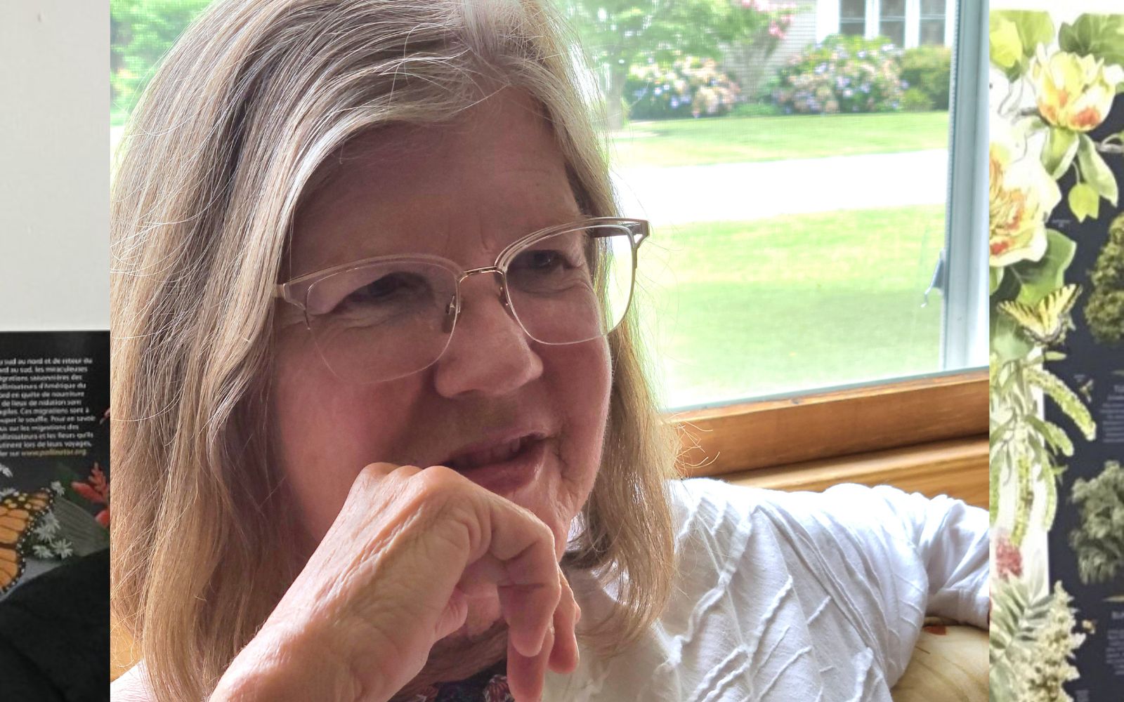 A woman with glasses sitting in front of a window.