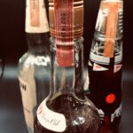 A close up of three bottles with different flavors