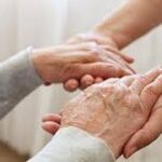 Two people holding hands in a room.