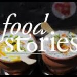 A couple of bowls filled with food on top of a table.