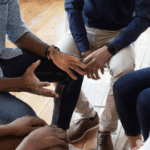 A group of people sitting on the floor