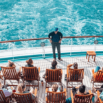 A man standing on the deck of a boat