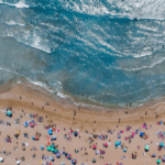 A beach with people and umbrellas on it