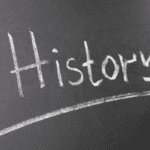 A chalkboard with the word " history " written in chalk.