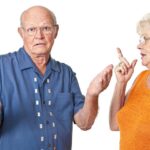 An older man and woman are standing together.