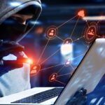 A person in black jacket using laptop computer.