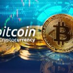 A close up of some gold coins with the word bitcoin in front.