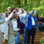 A group of people standing in the woods