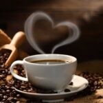 A cup of coffee with steam coming out it.