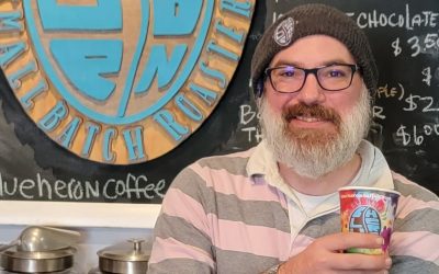 A man holding onto a can of coffee