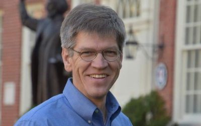 A man with glasses and a blue shirt