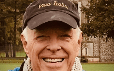 A man wearing a hat and smiling for the camera.