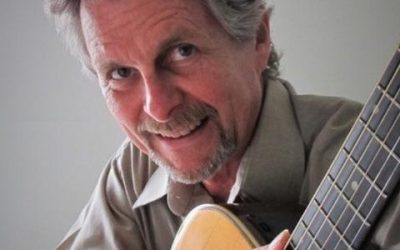 A man with a guitar in his hands.