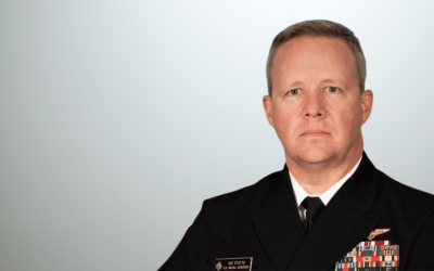 A man in military uniform with a beard.